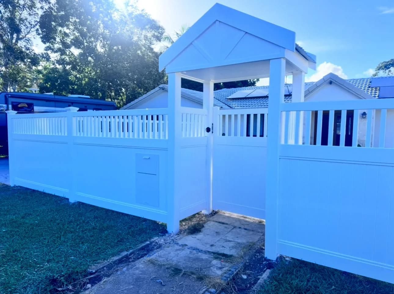 Semi-privacy PVC fence with gabled gate entry and integrated letterbox Gold Coast
