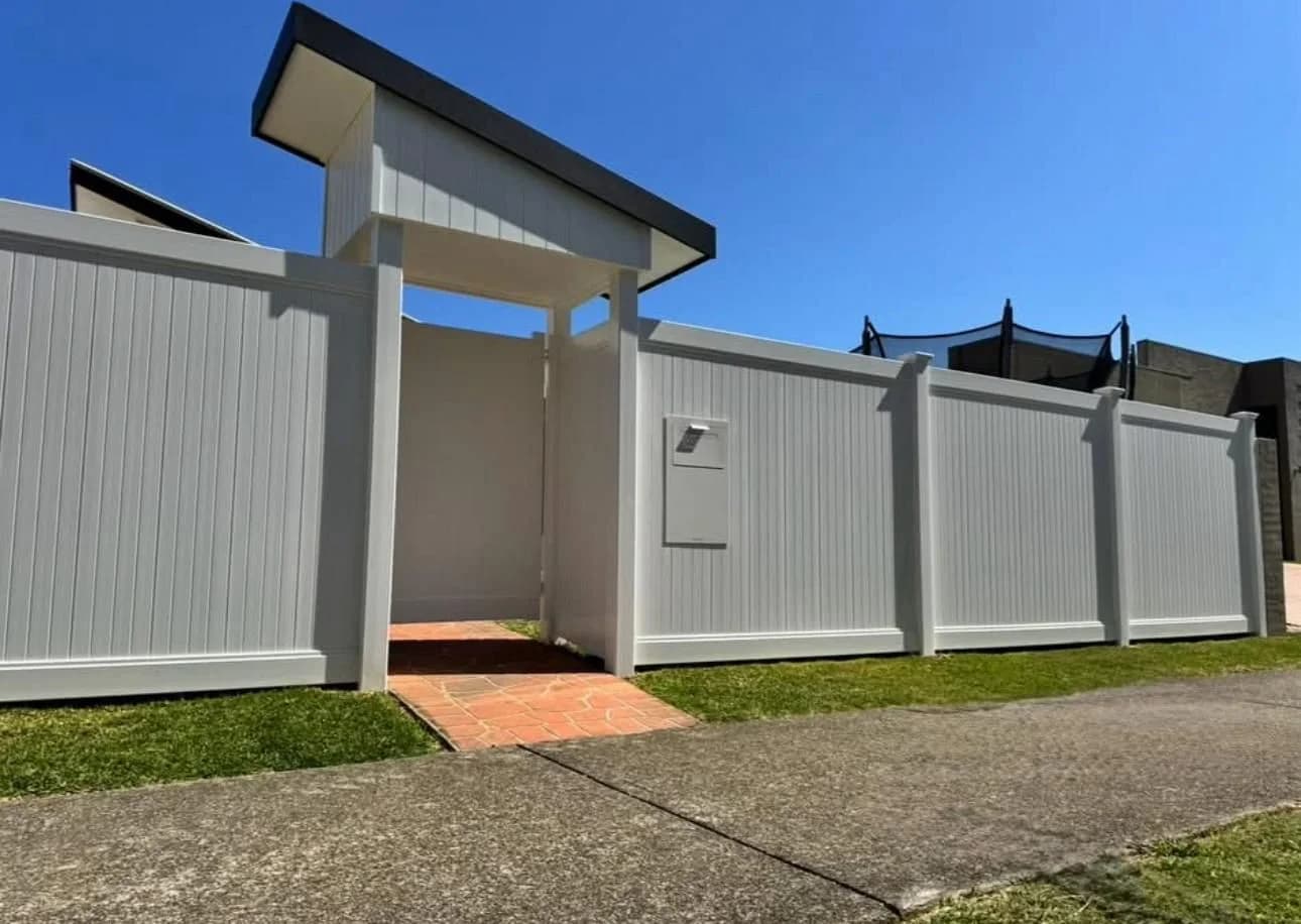 Full privacy PVC front fence with covered entry portico and letterbox