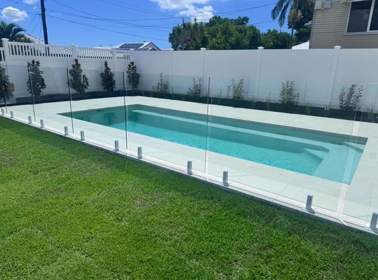 Privacy PVC fence as pool boundary with semi-privacy lattice top